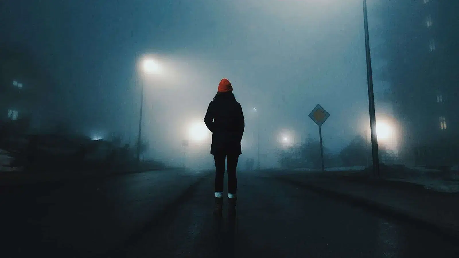 woman walking in a foggy street