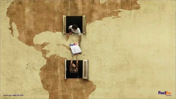 person passing parcel to neighbour with a map on the wall