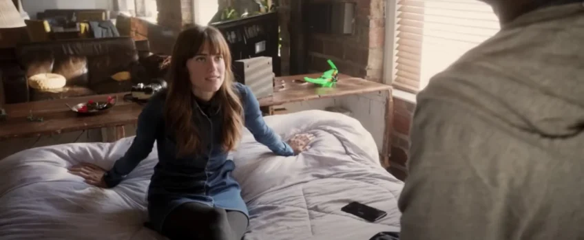 actress sitting on the bed