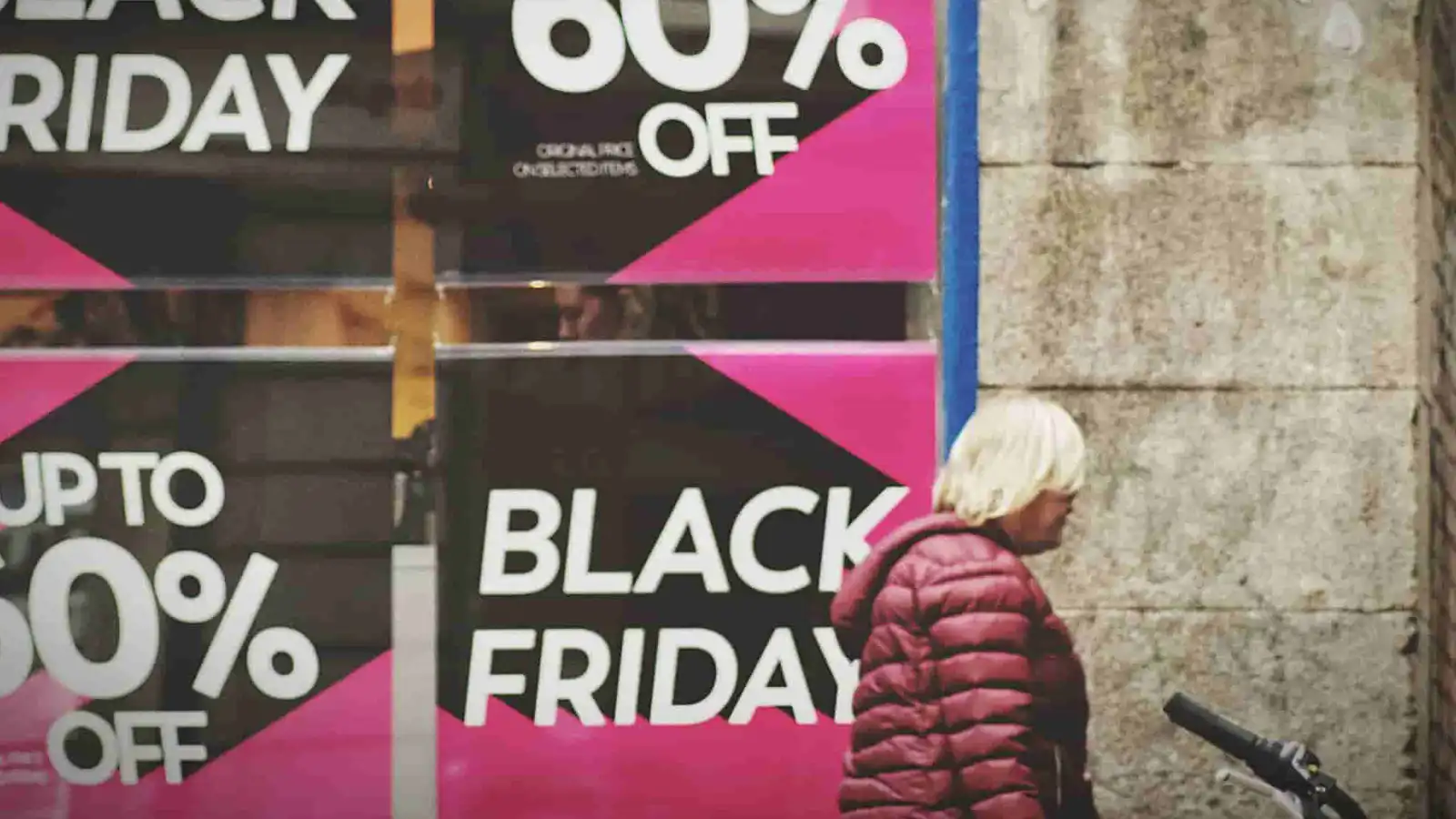 woman walking past sales signs