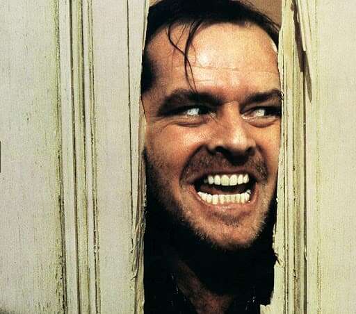 Jack Nicholson pokes his head through a broken door