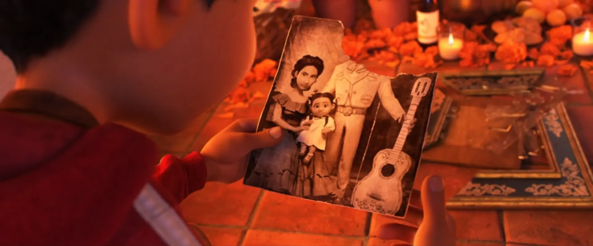 Miguel looking at an image of his ancestors posing in a photograph
