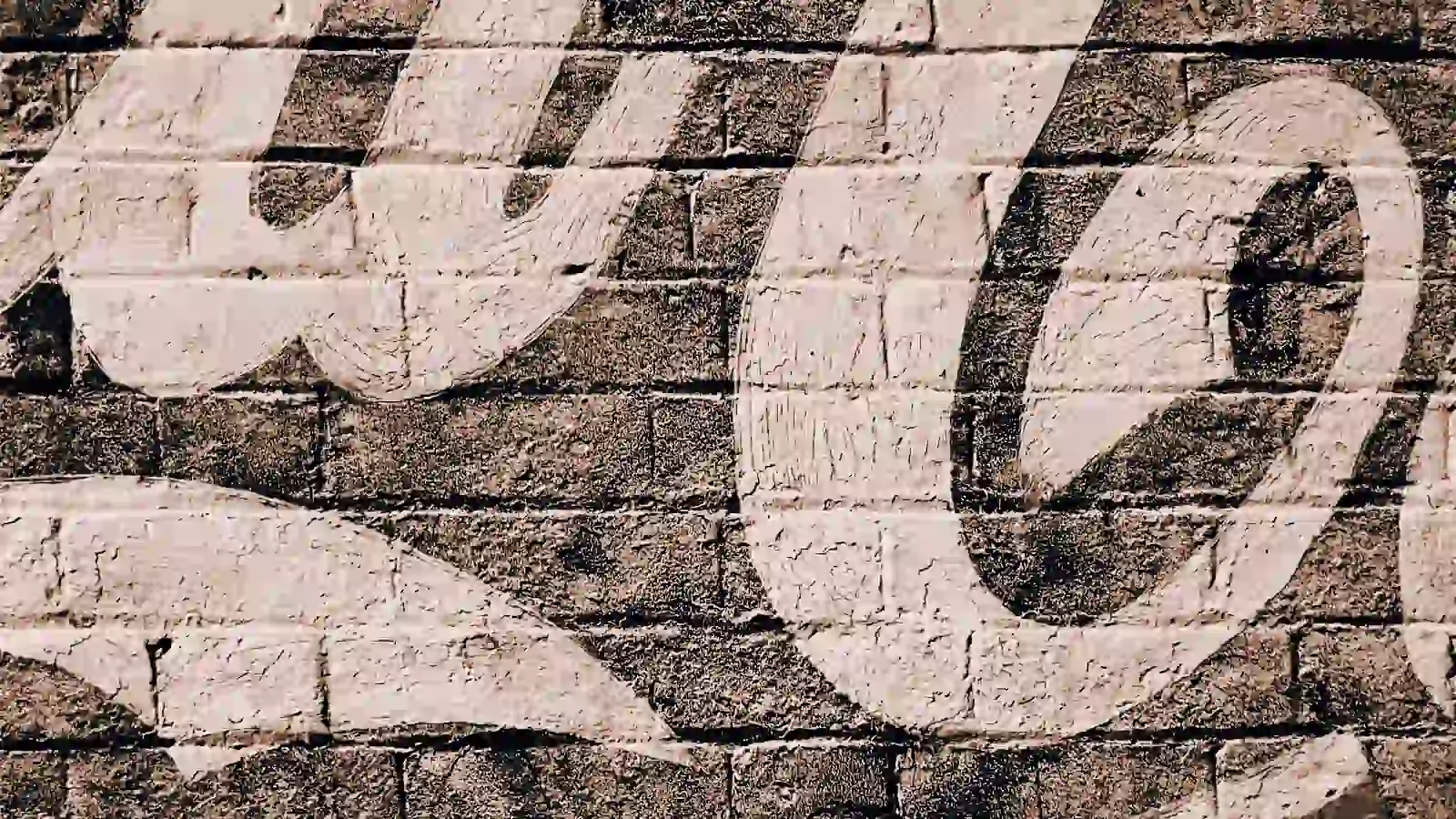 Coke logo on a brick wall