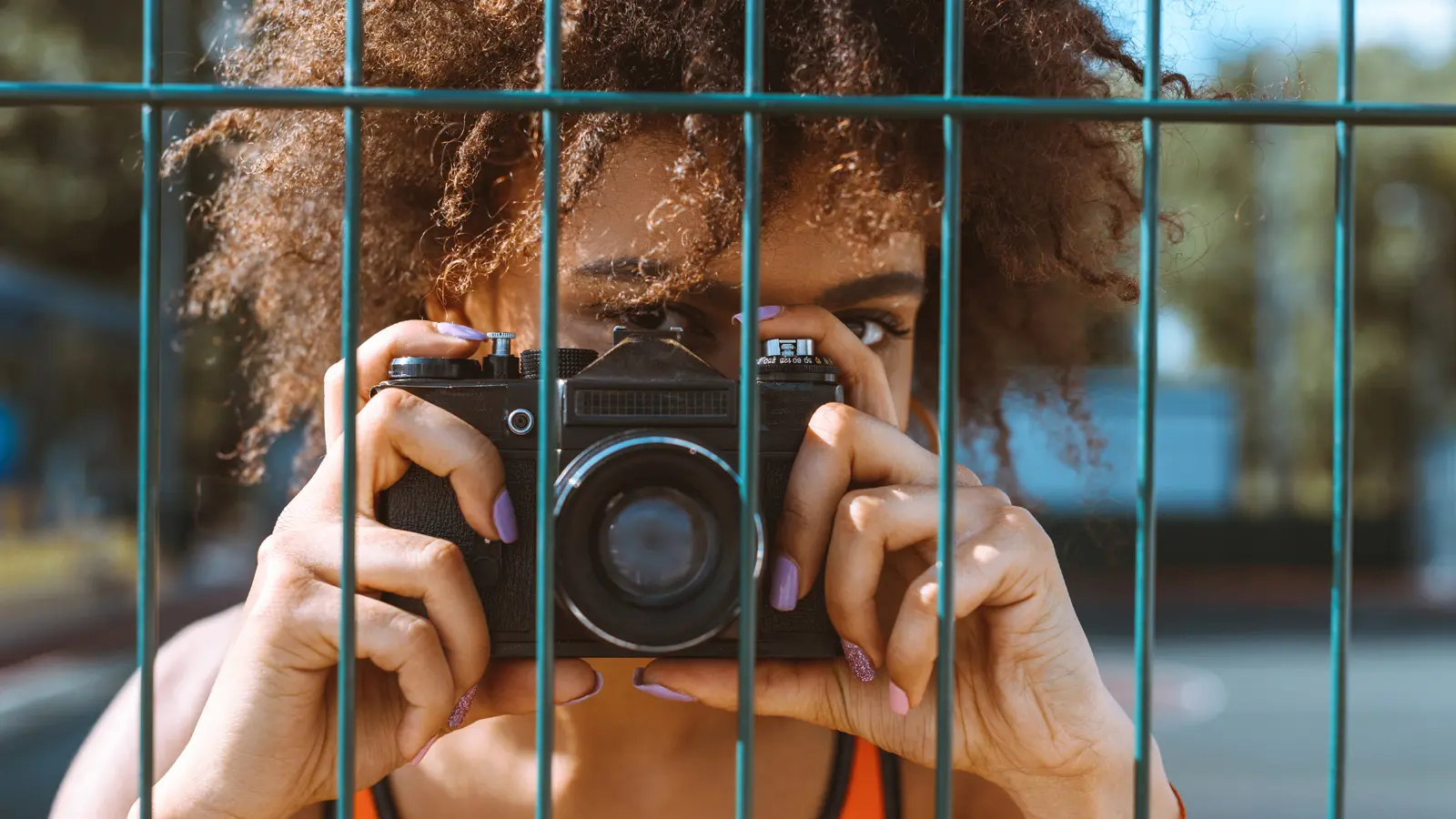 young woman taking a picture with her camera