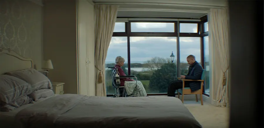 Chris sitting opposite his mother