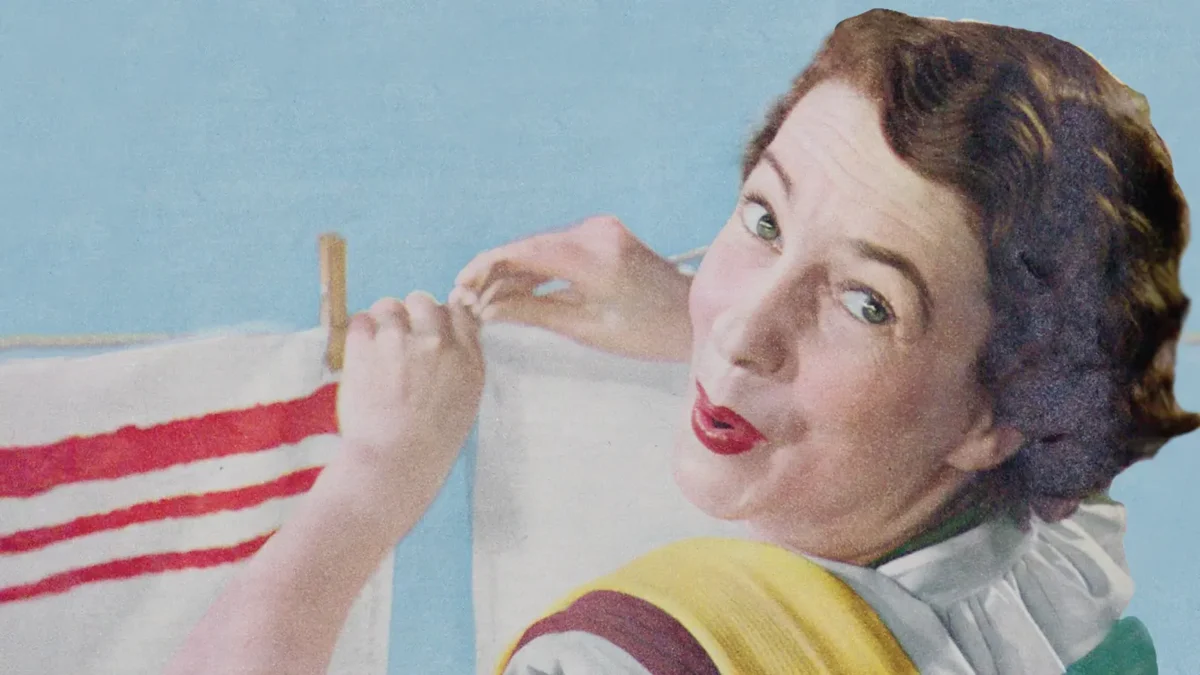 women hanging clothes on a washing line