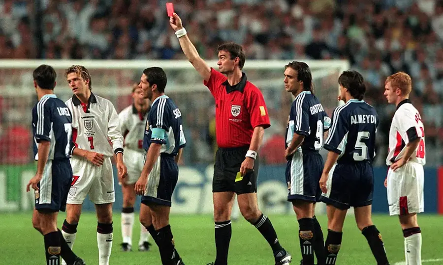 Beckham being shown a red car by the referee