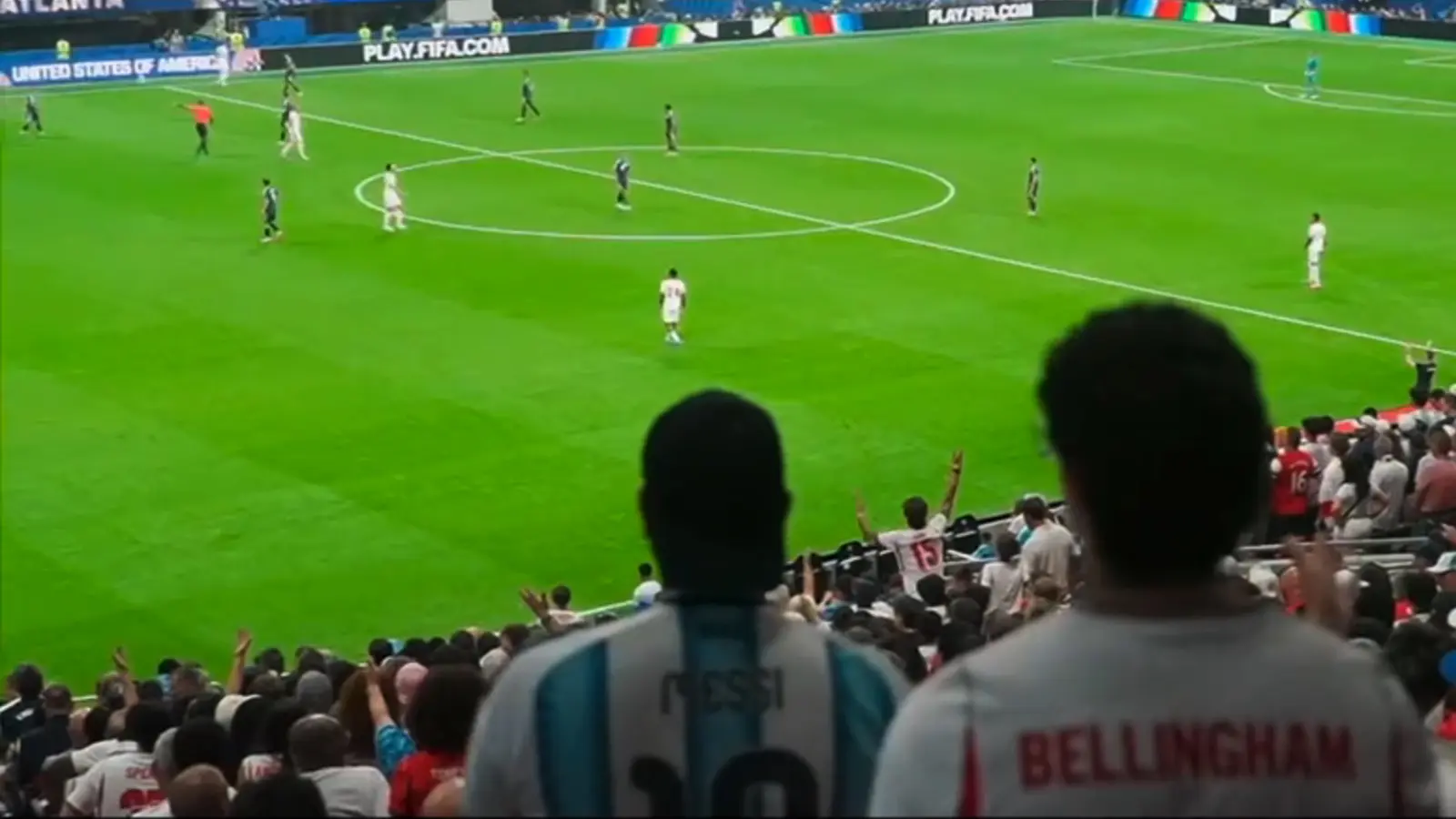 supporters watching the football game from the stands